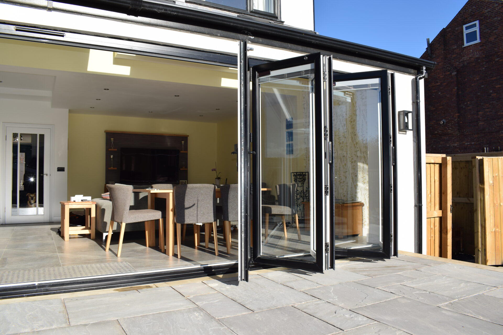home extension ideas: living room extension with bifold doors fitted and opened wide