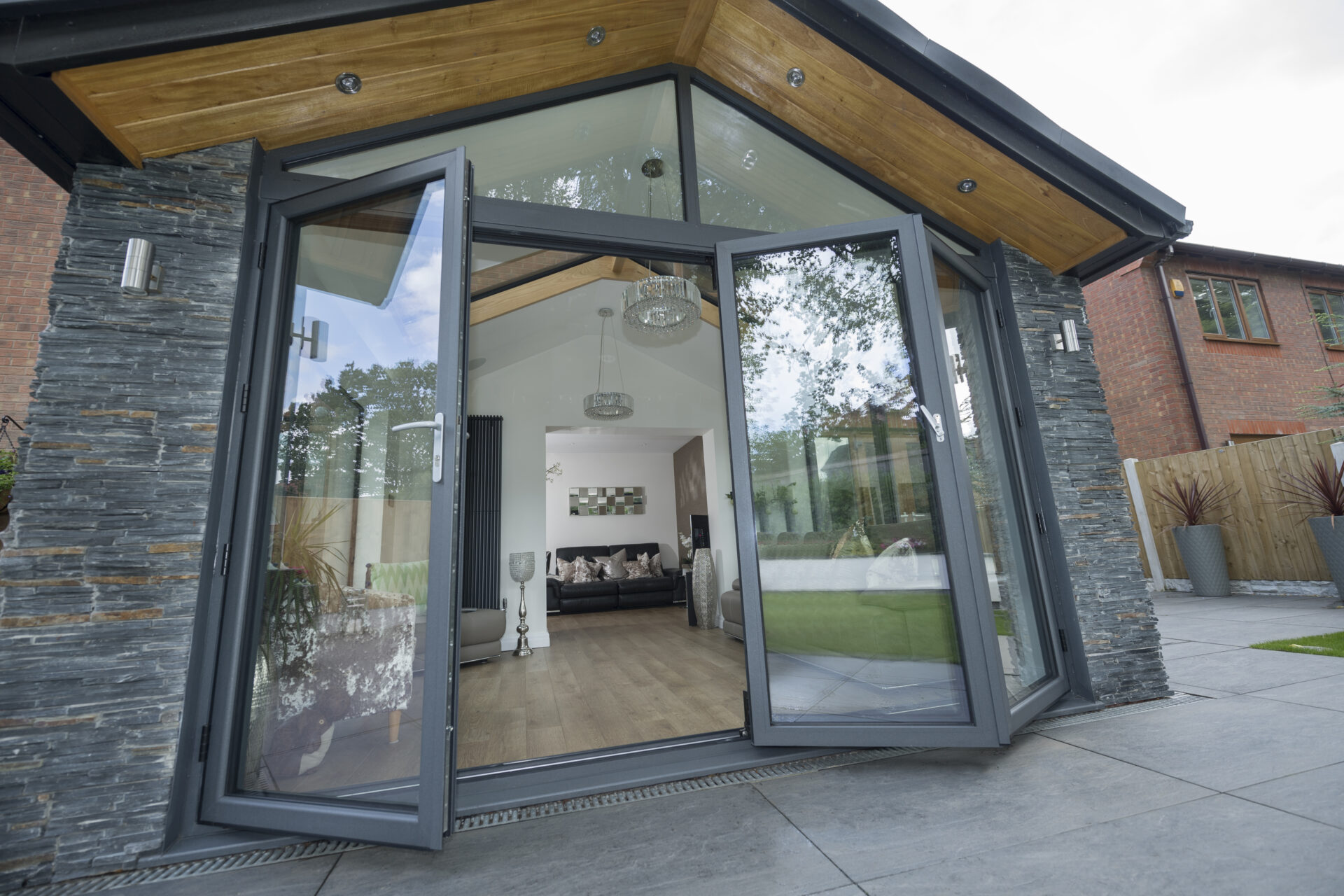 Bi-fold Doors : smart bifold doors opening showing off the dedicated traffic door