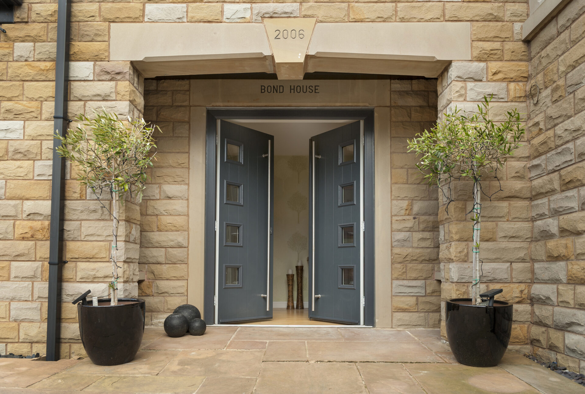 Solidor composite doors: French doors with long bar handles and stunning brickwork around the doors