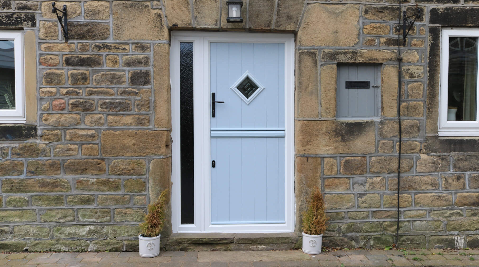 Stable Doors : light blue stable door against a stonewall