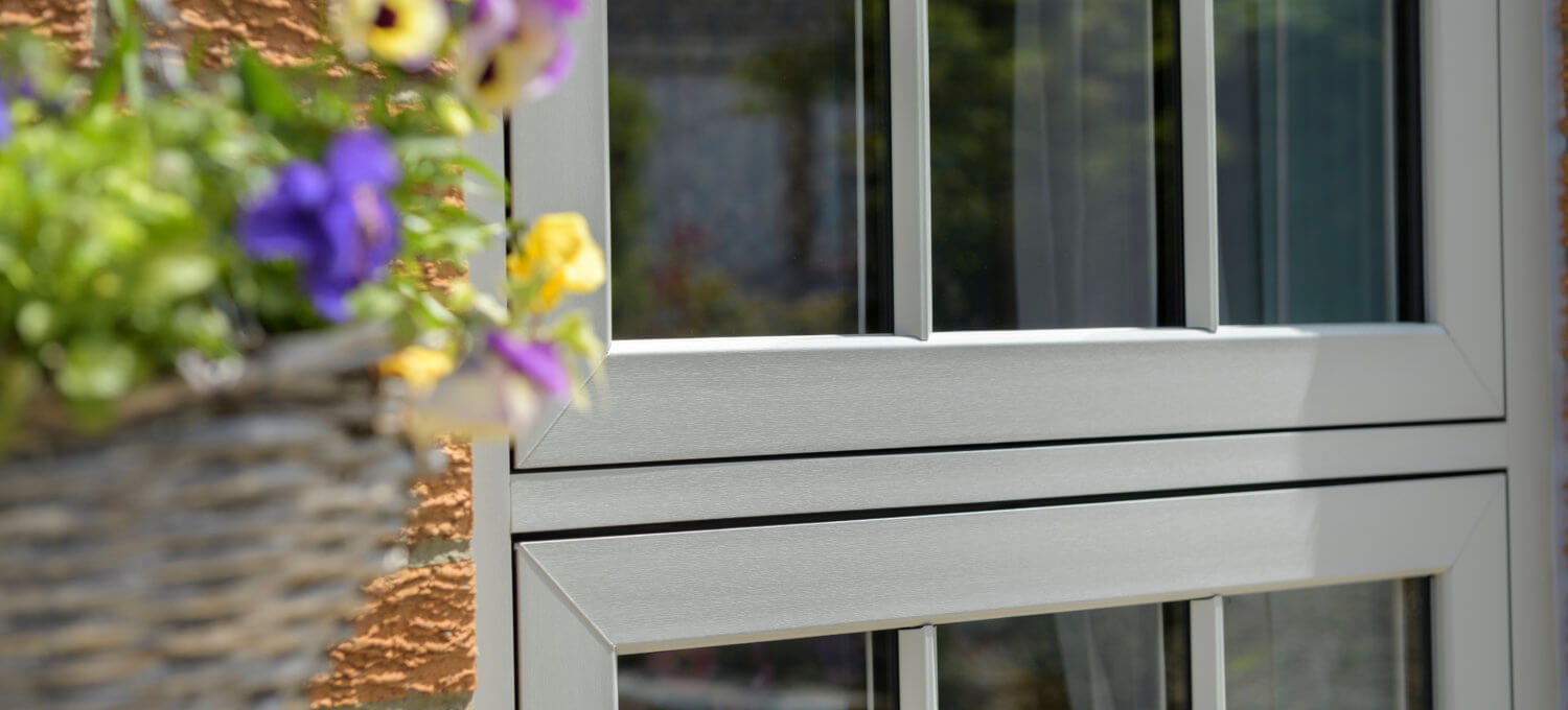 How Much Will New Windows Save On Energy? : Window zoomed in with flower basket hanging on the left of the window.