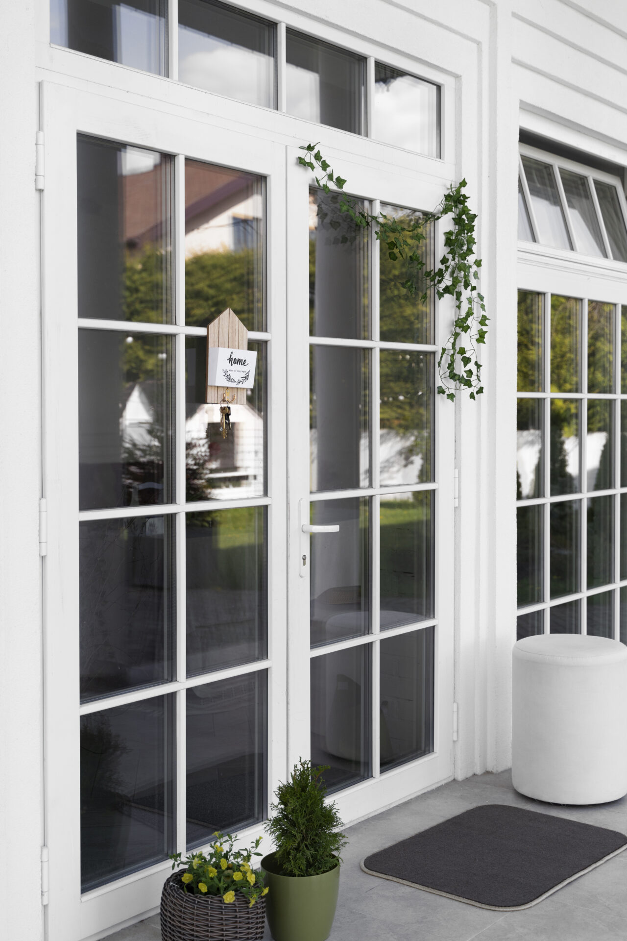 Double glazed doors in white, decorated with green ivy.