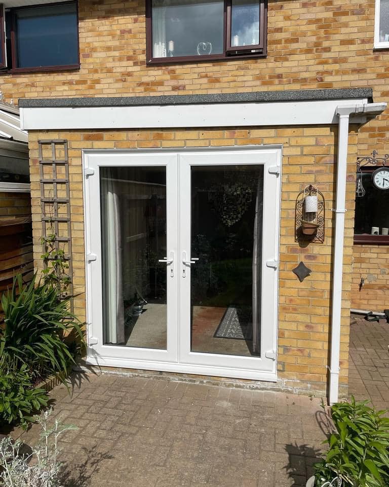 Double glazed doors installed at the rear of a property with both doors closed.
