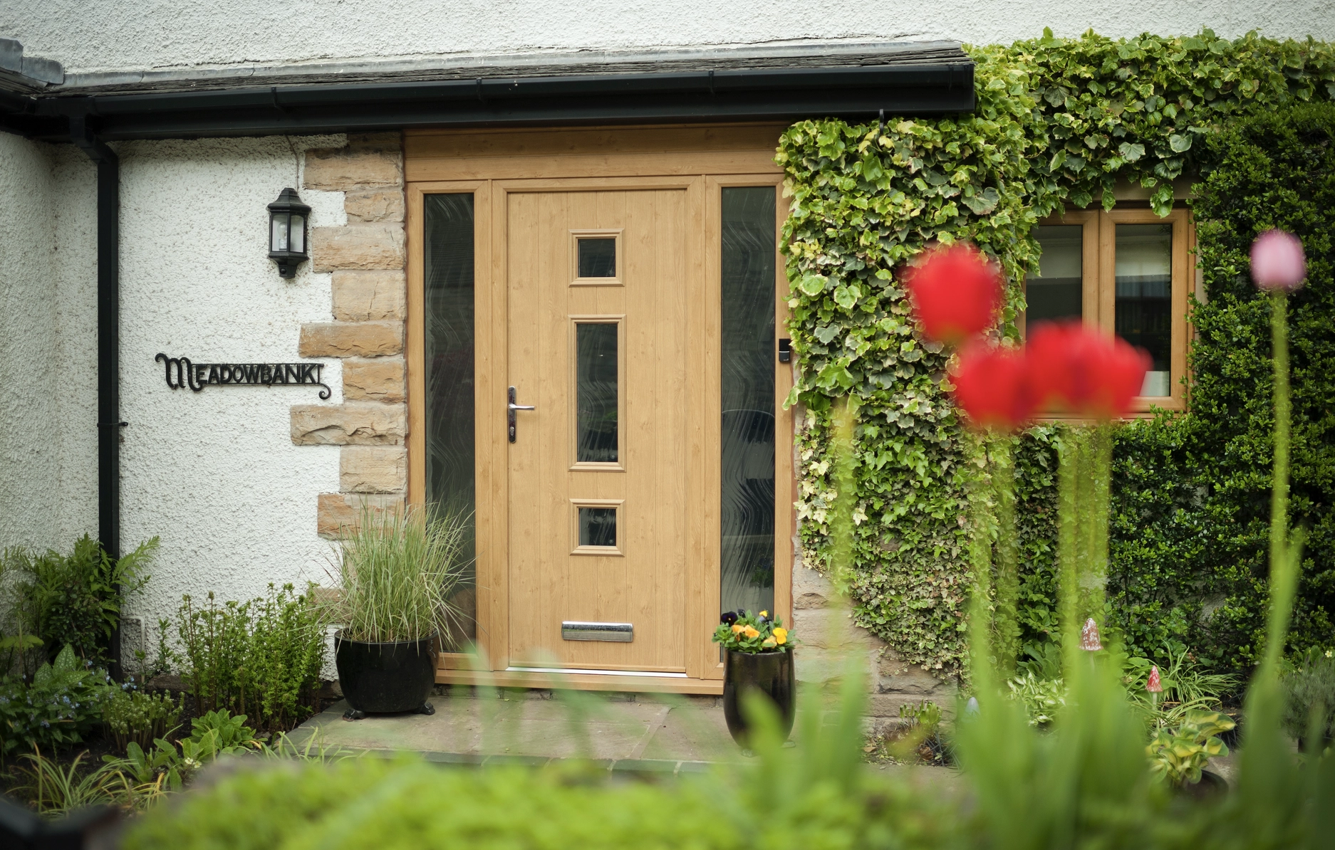 front door: Solidor Genoa composite door in irish oak with full glass panels.